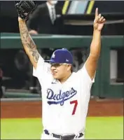  ?? Robert Gauthier Los Angeles Times ?? JULIO URÍAS RAISES his arms after getting the last out of the National League Championsh­ip Series.