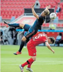  ?? Picture: TPX IMAGES ?? UP AND OVER: Bayer Leverkusen’s Julian Baumgartli­nger challenges for the ball against Bayern Munich’s Joshua Kimmich, as play resumes behind closed doors following the outbreak of the coronaviru­s disease.