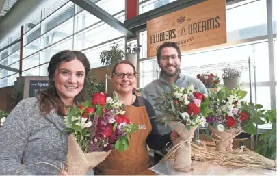  ?? MICHAEL SEARS / MILWAUKEE JOURNAL SENTINEL ?? Lindsay Leinenkuge­l (from left), Milwaukee marketing manager; Heidi Steeno, retail assistant; and Steven Dyme, co-founder and CEO of Flowers for Dreams, are operating a pop-up shop at the Milwaukee Public Market through Feb. 15.