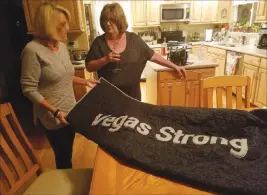  ?? Mike Shoro ?? Las Vegas Review-journal Barbara Godron, left, with her friend Karen Berney, holds up a quilt she received as a gift inside of Godron’s Las Vegas home on Nov. 17.