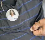  ??  ?? Kaur’s face adorns a button worn by her uncle Jaipal Walia. The dentist from India was 37 when she was slain in 2015 in her Albany apartment.