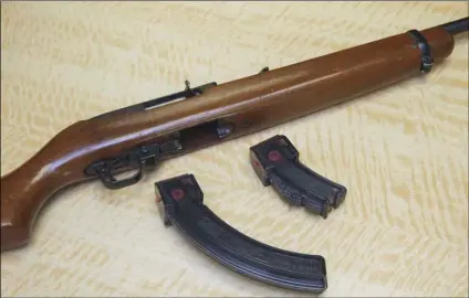  ?? AP Photo/Rich Pedroncell­i ?? In this 2017 file photo, a semi-automatic rifle is displayed with a 25 shot magazine, left, and a 10 shot magazine (right) at a gun store in Elk Grove, Calif.