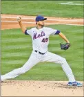  ?? Seth Wenig / Associated Press ?? New York Mets starting pitcher Jacob deGrom throws during the third inning of the game against the Atlanta Braves at Citi Field on Friday in New York.