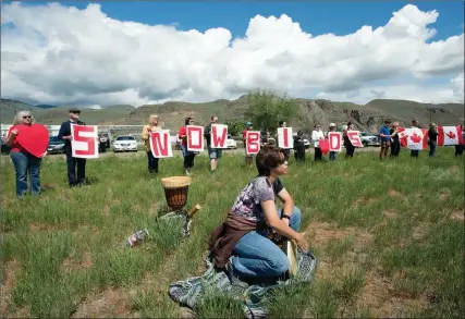  ?? The Canadian Press ?? Kamloops residents and local First Nation members take part in a drum ceremony to remember fallen Snowbirds Capt. Jenn Casey near Kamloops airport on Monday. Casey died Sunday after the jet she was in crashed shortly after takeoff.