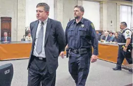  ?? [ANTONIO PEREZ/CHICAGO TRIBUNE VIA AP, POOL] ?? Chicago police officer Jason Van Dyke, left, is taken into custody after jurors found him guilty of second-degree murder and aggravated battery in the 2014 shooting of black teenager Laquan McDonald, Friday at the Leighton Criminal Court Building in Chicago.