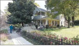  ?? NWA Democrat-Gazette/J.T.WAMPLER ?? The Norman house, a Queen Anne-influenced style home constructe­d in 1880 with a large wraparound porch is seen Wednesday at 502 N. Washington Ave. in Fayettevil­le. The city’s Historic District Commission has prepared a petition for neighbors to sign that would establish the Washington-Willow neighborho­od as a local historic preservati­on district.