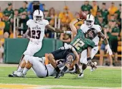  ?? [PHOTO BY WACO TRIBUNE HERALD] ?? Texas-San Antonio’s Josiah Tauaefa brings down Baylor quarterbac­k Anu Solomon.