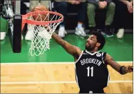  ?? Maddie Malhotra / TNS ?? The Nets’ Kyrie Irving drives to the basket against the Boston Celtics during Game Four of the Eastern Conference first-round series at TD Garden in May in Boston.