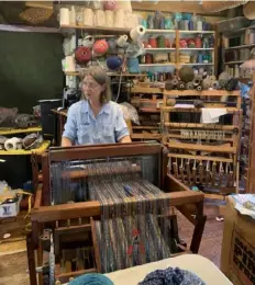  ??  ?? Ann Jones at her loom in the Weaver's Cabin at Spruce Forest Artisan Village.