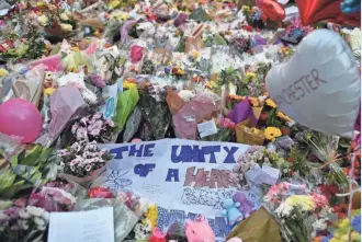  ?? BEN STANSALL, AFP/GETTY IMAGES ?? A carpet of flowers and messages lie Wednesday at St Ann’s Square in Manchester, England, placed in tribute to the victims of Monday’s terror attack at the Manchester Arena.