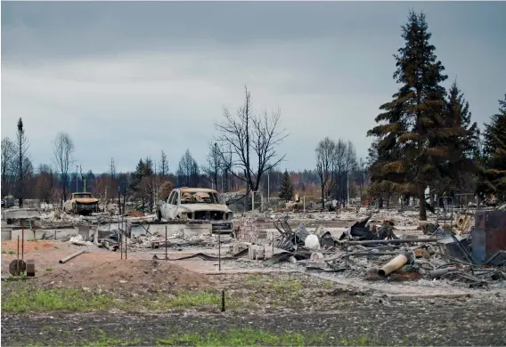  ??  ?? In 2011, a devastatin­g wildfire ripped through Slave Lake, Alta., destroying much of the town and forcing thousands of people to flee their homes