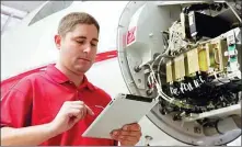  ??  ?? An engineer uses Honeywell’s GoDirect connected maintenanc­e system to monitor an airplane’s safety conditions.