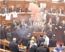  ?? GETTY IMAGES ?? Opposition MPs set off smoke bombs during a vote for a new, temporary general prosecutor on Monday in Tirana, Albania.