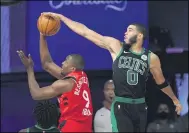  ?? MARK J. TERRILL — THE ASSOCIATED PRESS ?? The Celtics’ Jayson Tatum blocks the shot of the Raptors’ Serge Ibaka on Sept. 7in Lake Buena Vista, Fla.