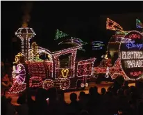  ?? DON KELSEN/LOS ANGELES TIMES ?? The dazzling and colorful “Disney’s Electrical Parade” shines at Disneyland in 2001. The nighttime parade of 22 floats, dozens of dancers and 600,000 blinking lights will run until Aug. 20, the park has announced.