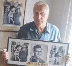  ?? Picture: AP ?? George Mendonsa holding a copy of the famous photo.