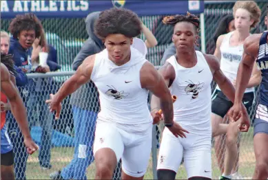  ?? Jeremy Stewart ?? Rockmart’s Cam Ferguson (left) gets the baton from teammate Rakaylin Glover for the final leg of the boys’ 4x100-meter relay during the Class AA “B” sectional at Rockmart High School on Saturday, May 6. The team finished second overall with a time of 42.73 seconds to earn a spot in the state finals this week at McEachern High School.