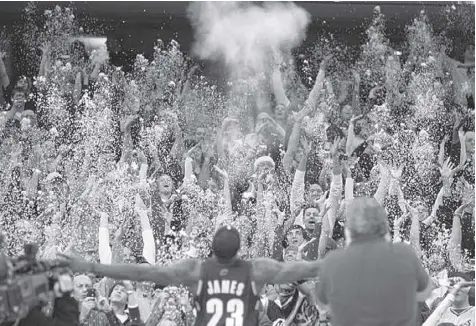  ??  ?? FANS toss confetti to mimic then Cleveland Cavaliers’ Lebron James’s pregame chalk toss before their National Basketball Associatio­n game against the Washington Wizards in Cleveland in December 2008.