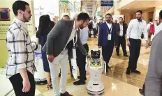  ?? Clint Egbert/Gulf News ?? Robots interact with people at the Dubai World Trade Centre.