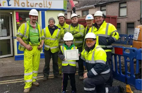  ??  ?? 11-year-old John Beary receives his special certificat­e from the Gas Networks contractor­s at Francis Street.