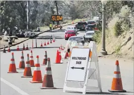  ?? Allen J. Schaben Los Angeles Times ?? TRAFFIC ON Mt. Hollywood Drive leads toward the Hollywood sign, which has stirred new debate over how to protect neighborho­ods yet allow access to the view.