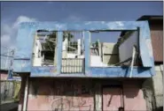  ?? CARLOS GIUSTI - THE ASSOCIATED PRESS ?? In this June 13 photo, a residence in the Figueroa neighborho­od stands destroyed nine months after Hurricane Maria, in San Juan, Puerto Rico. While the Department of Housing channels millions in federal funds through the “Tu Hogar Renace” program to...