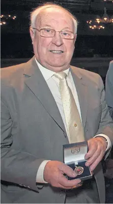  ??  ?? Bobby Waddell with his Dundee league title medal.