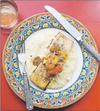  ?? AP PHOTO ?? Salmon perched atop a bed of polenta, piled with a mound of roasted cherry tomatoes, seems to speak of a promise of warmer meals to come.