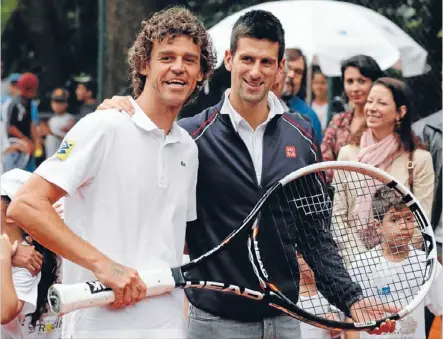  ?? Photo: Reuters ?? Novak Djokovic was in Rio de Janeiro yesterday for the opening of a tennis court in a shantytown and a football match with some former Brazil stars. Djokovic joined Brazilian champion Gustavo Kuerten, above, for the inaugurati­on of the public court in...