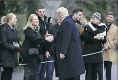  ??  ?? President Donald Trump greets White House visitors Friday before leaving the White House in Washington for a trip to Quantico, Va., to attend the FBI National Academy graduation ceremony.