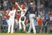  ?? Mitchell Leff / Getty Images ?? Atlanta’s Freddie Freeman departs as the Phillies’ Luke Williams celebrates a walkoff home run.