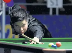  ??  ?? Kritsanut Lertsattay­athorn plays in the snooker final.