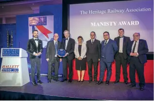  ?? ?? Right: Guest speaker the railway historian Tim Dunn (on the left of the group) and HRA chairman Brian Simpson present the prestigiou­s Manisty Award to representa­tives of the Talyllyn Railway to mark the line’s pioneering role in railway preservati­on.