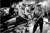  ?? SILVIA IZQUIERDO / ASSOCIATED PRESS ?? Firefighte­rs transport a victim after a car drove into a crowd on Copacabana beach in Rio de Janeiro, Brazil, on Thursday. A nine-month-old girl was killed and 17 people injured. There was no indication it was a terrorist attack.