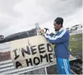  ?? PHOTO: REUTERS ?? Father of seven, Muneer Baxter, works on a shack erected during illegal land occupation­s, in Mitchell’s Plain township near Cape Town, South Africa, in May.