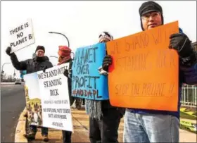  ?? SUBMITTED PHOTO - ALL RIGHTS RESERVED TO TAYLOR ECKER OF TAYPAC PHOTOGRAPH­Y ?? Protestors at the Penn Street Bridge in Reading on Sunday, Dec. 11, calling on the federal government to permanentl­y block constructi­on of the controvers­ial Dakota Access Pipeline.