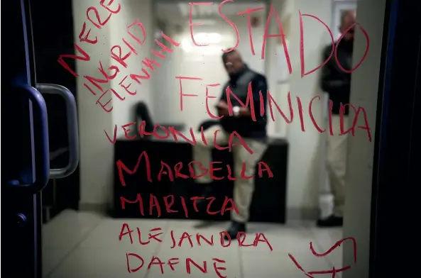  ?? PHOTOS: AP ?? The names of murdered women and the words ‘‘Femicide state’’, written in lipstick by protesters, cover a door at the prosecutor’s office in Tijuana. Feminist groups are encouragin­g Mexico’s 21 million registered female workers to stay home today to draw attention to violence against women and the authoritie­s’ weak response to the problem.