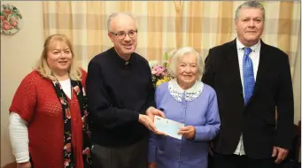  ??  ?? 100 year old Nan McGrath, Banteer, being presented with the President’s cheque from Rev. Fr. Wm. Winter P.P. in the company of her family Mary and Mark.