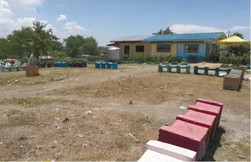  ??  ?? A daycare center and some concrete benches were put up last year in a portion of the former Umapad dump that Mandaue City is converting into an eco-park. (Above) The City serves notice.