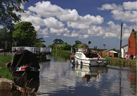  ?? PHOTO: COLIN WAREING/COLIN & CAROLE’S CREATIONS ?? A cruiser passes through Crabtree Lane Swing Bridge on the Leeds & Liverpool Canal as leisure boating returns after the lockdown.