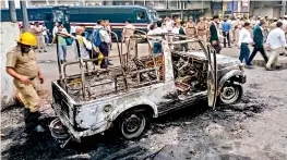  ?? — PTI ?? A view of a police vehicle after it was burnt down during clashes between lawyers and police personnel at Tis Hazari Court complex in New Delhi on Saturday.