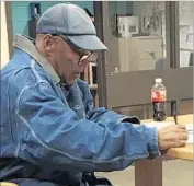  ?? Nevada Department of Correction­s ?? O.J. SIMPSON signs documents before leaving the Lovelock Correction­al Center at 12:08 a.m. Sunday.