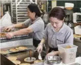  ??  ?? Sweet red bean pancakes, called hotteok, are made at Hado Kwaja Korean bakery.