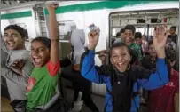  ?? ZAKIR HOSSAIN CHOWDHURY / ANADOLU AGENCY ?? Underprivi­leged children celebrate after a free metro ride in Dhaka, Bangladesh, on Jan 30. The Ministry of Women and Children Affairs organized the event for over 800 children, 474 of whom won the National Children’s Award Competitio­n in 2020 and 2021. Around 200 live at the Shishu Bikash Kendras in Azimpur and Keraniganj, and 135 are homeless.