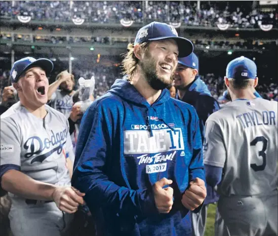  ?? Photograph­s by Wally Skalij Los Angeles Times ?? CLAYTON KERSHAW and the Dodgers were all smiles after beating the Cubs to reach the World Series, where they lost to the Houston Astros in seven games.