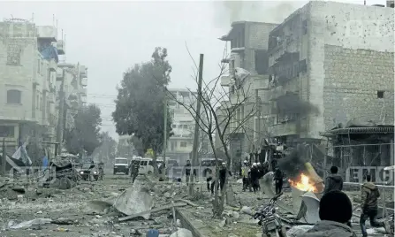  ?? EDLIB MEDIA CENTER/THE ASSOCIATED PRESS ?? Members of the Syrian civil defence known as the White Helmets, gather at a street which was attacked by Russian airstrikes, in Maarat al-Nuaman town, southern Idlib province, Syria. Syrian government forces and allied militiamen are advancing on the...