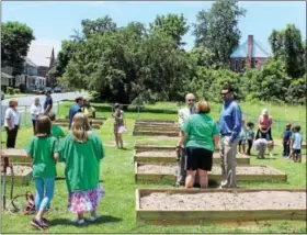  ?? MICHILEA PATTERSON — DIGITAL FIRST MEDIA ?? The community came out to Barth Elementary School June 10 for the official opening of the school’s new garden which has 23 plots. The garden will be used by students and people in the neighborho­od.