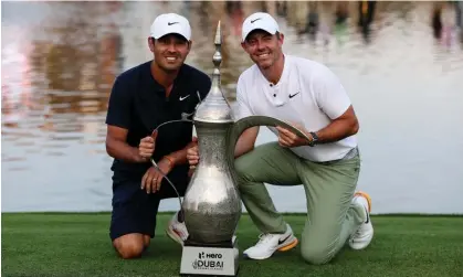  ?? ?? Rory McIlroy and his caddie, Harry Diamond, pose with the trophy. Photograph: Ali Haider/EPA