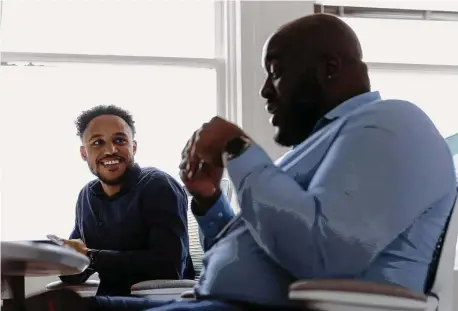  ?? Photos by Bee Trofort/New York Times ?? Dr. Darron Lewis, left, and Dr. Joshua Omade review a case with colleagues at Morehouse School of Medicine in Atlanta on Oct. 4. In Atlanta, a team of mental health experts is bringing care to adolescent­s whose needs often go unaddresse­d.