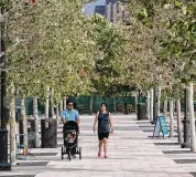  ?? ?? Abel Barraza and Grecia Canales stroll with their child, Bravlio Barraza, in the newly opened park.